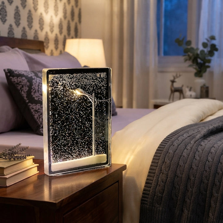 A Snowy Street Lamp Night Light glowing on a bedside table in a cozy bedroom with lavender and cream bedding.
